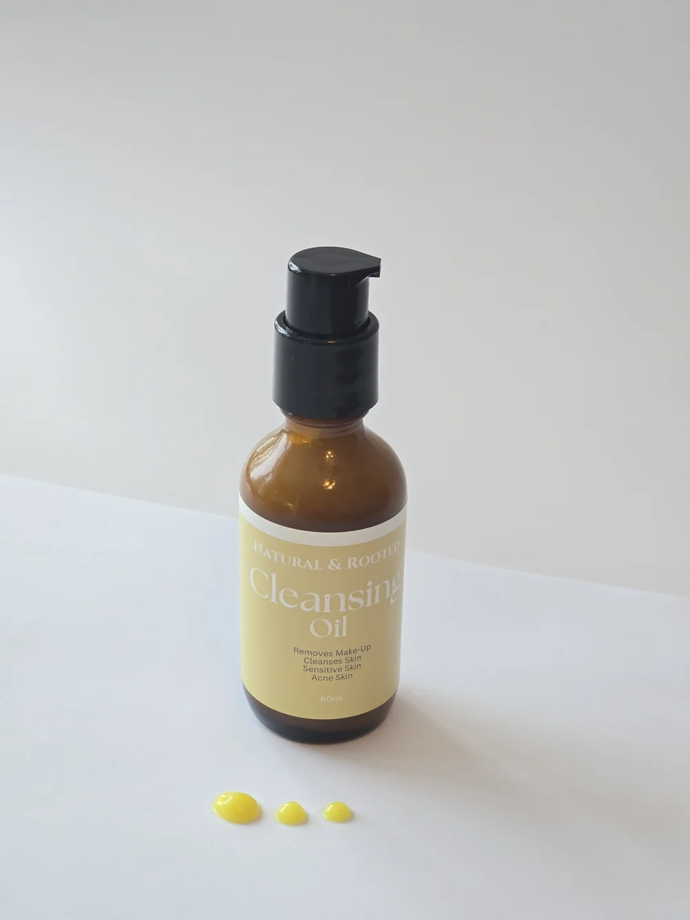 Oil Cleanser jar in a warm limestone botanical setting