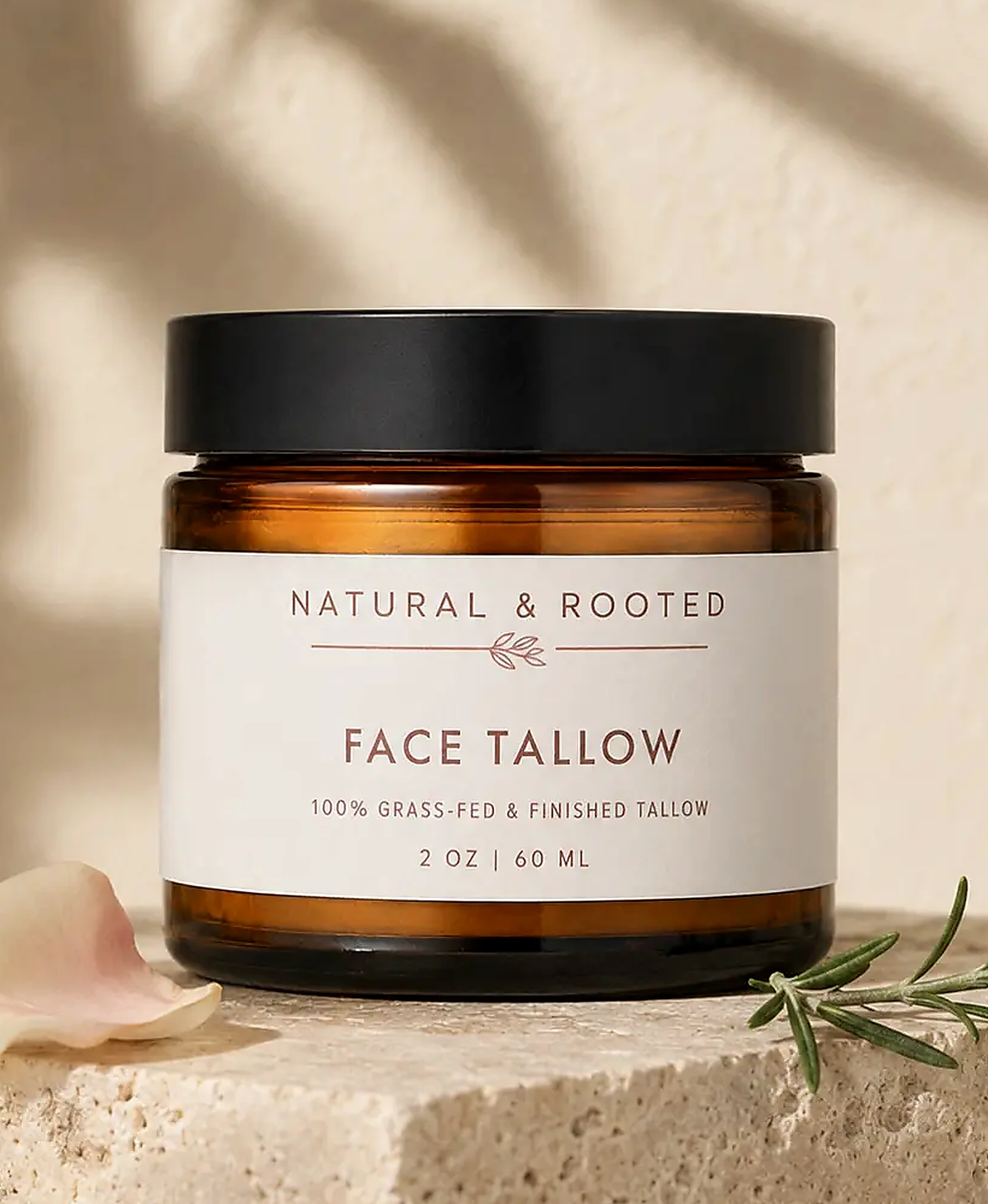 Natural and Rooted Face Tallow photographed on limestone with rose and rosemary