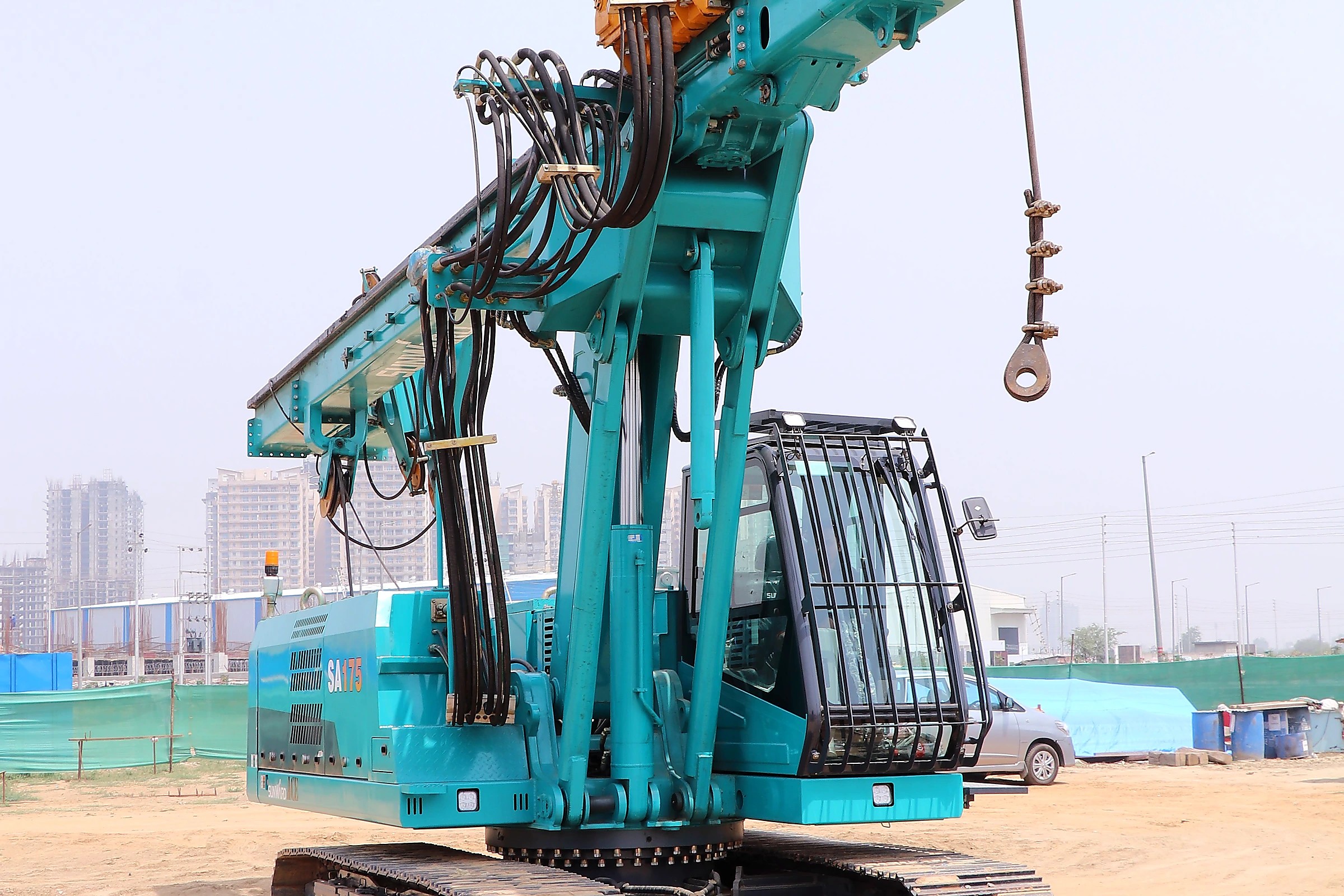 Large helical piling rig working at a foundation site