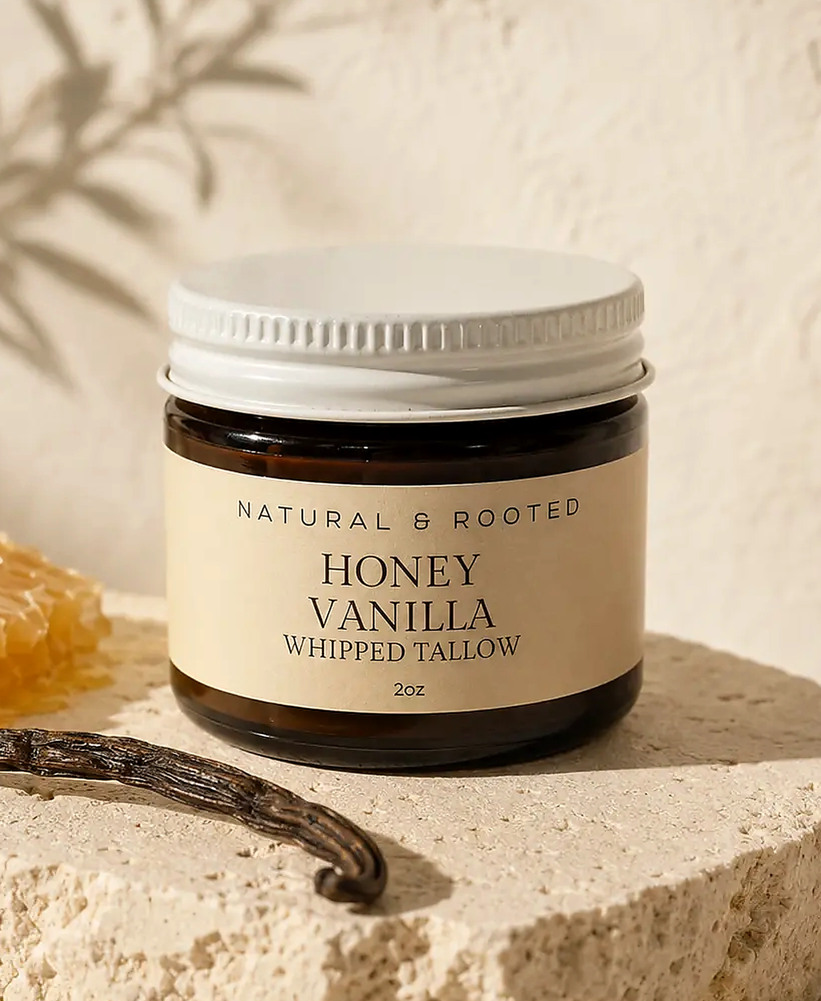 Honey Vanilla Whipped Tallow photographed on limestone with honeycomb and vanilla